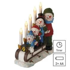 EMOS LED svietnik – snehuliaci na saniach, 24 cm, 2x AA, vnútorný, teplá biela, časovač